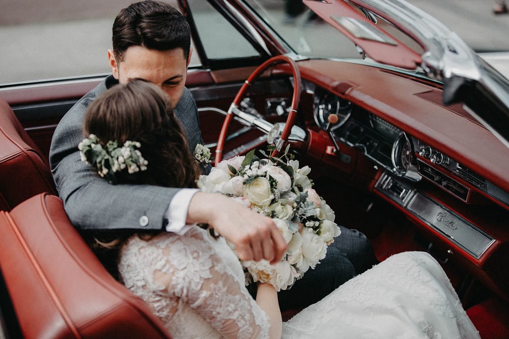 Newly married couple in a car