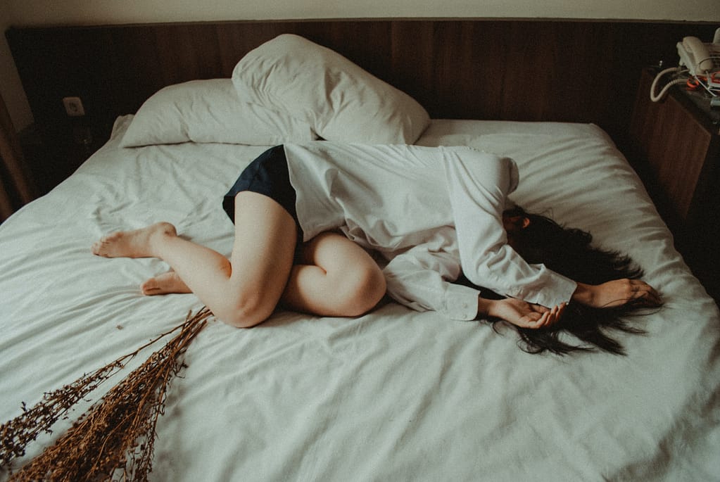 Girl lying in bed sad and drpressed